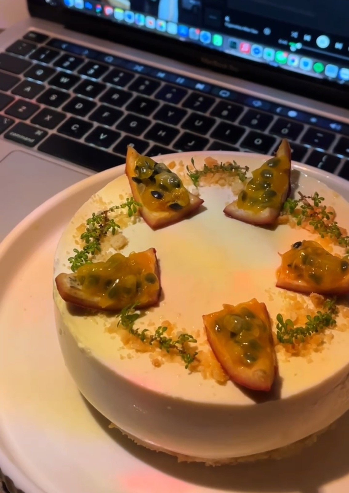 Clara’s passionfruit cake decorated with fruit and green sprigs